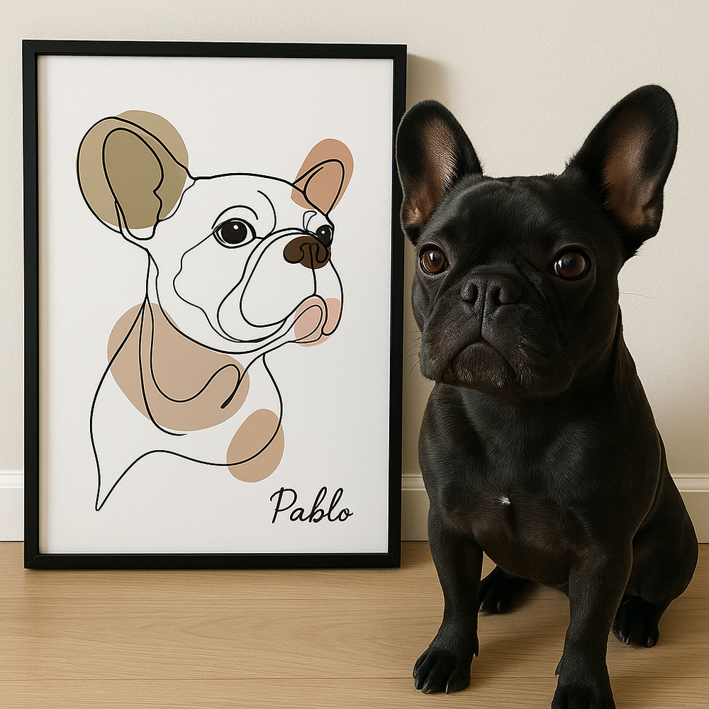 Black dog sitting next to a framed illustration of a dog named Pablo on a wooden floor.